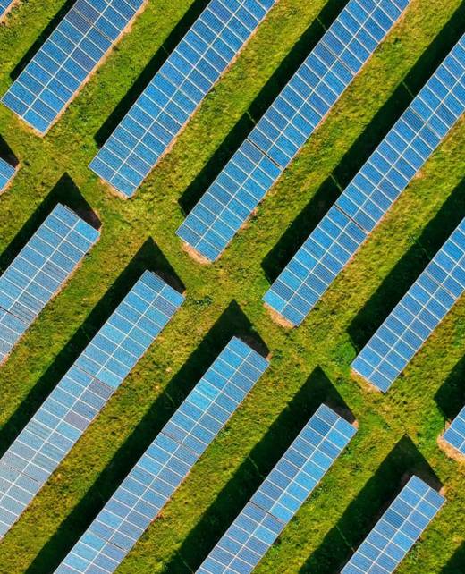 Aerial view of rows of solar photovoltaic panels in a regional Australian field